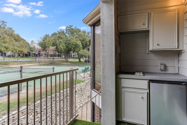 balcony featuring tennis court