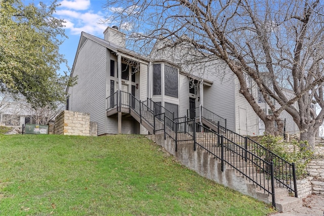 view of side of home featuring a yard