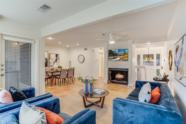 tiled living room featuring ornamental molding and ceiling fan with notable chandelier