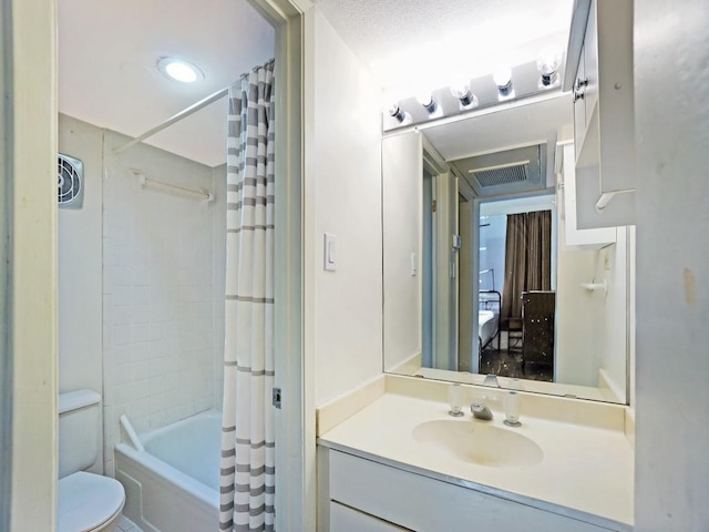 full bathroom with vanity, shower / tub combo with curtain, and toilet