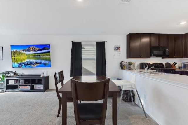 carpeted dining area featuring sink