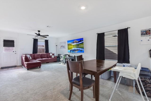 carpeted dining area featuring ceiling fan