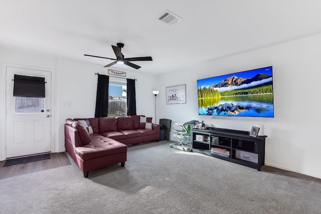 carpeted living room with ceiling fan