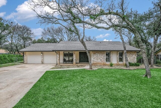 ranch-style home featuring a garage and a front lawn