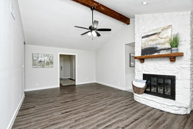 unfurnished living room featuring dark wood-type flooring, ceiling fan, a stone fireplace, and vaulted ceiling with beams