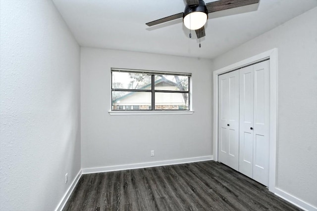 unfurnished bedroom with ceiling fan, dark hardwood / wood-style flooring, and a closet