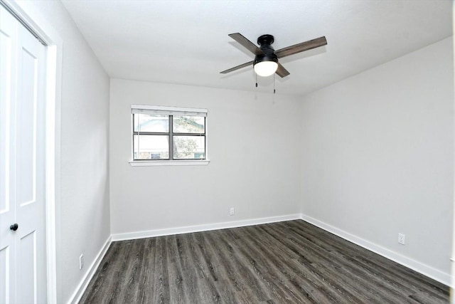 empty room featuring dark wood-type flooring and ceiling fan