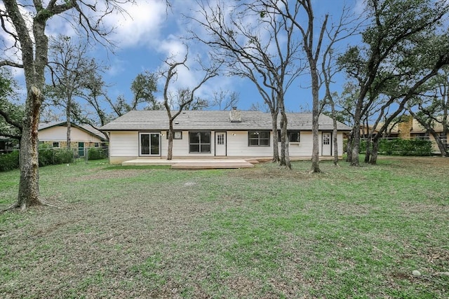 rear view of house featuring a lawn