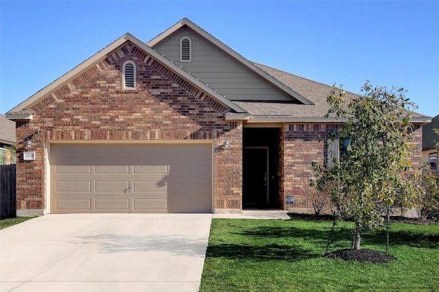 view of front of property featuring a garage and a front lawn