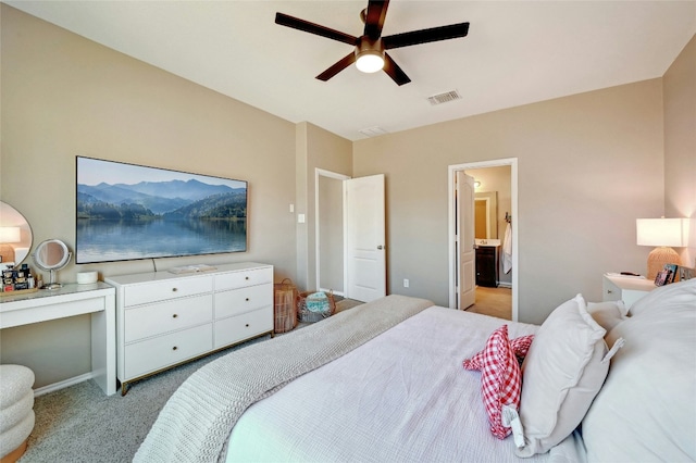 carpeted bedroom with ceiling fan and ensuite bathroom