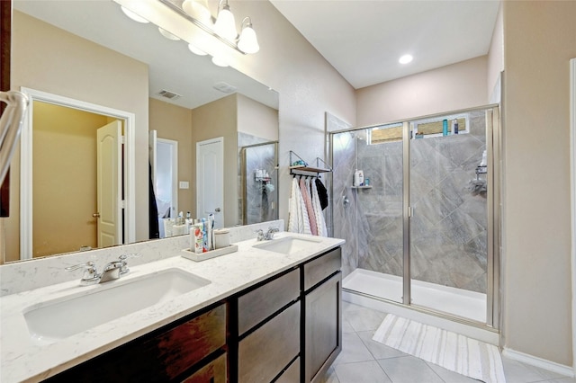 bathroom featuring vanity, tile patterned floors, and a shower with shower door