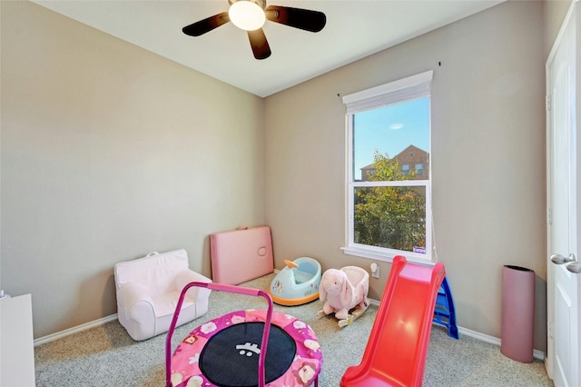 recreation room with ceiling fan and light colored carpet