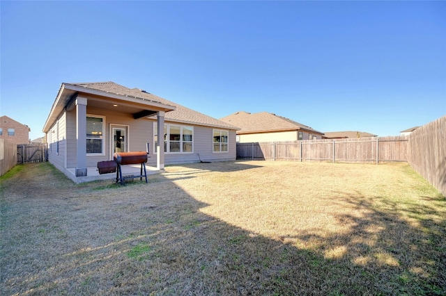 rear view of property featuring a yard