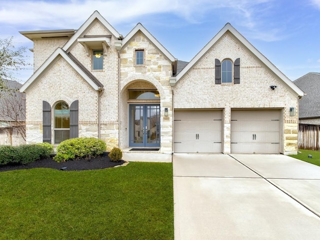 view of front of property with french doors, a garage, and a front yard