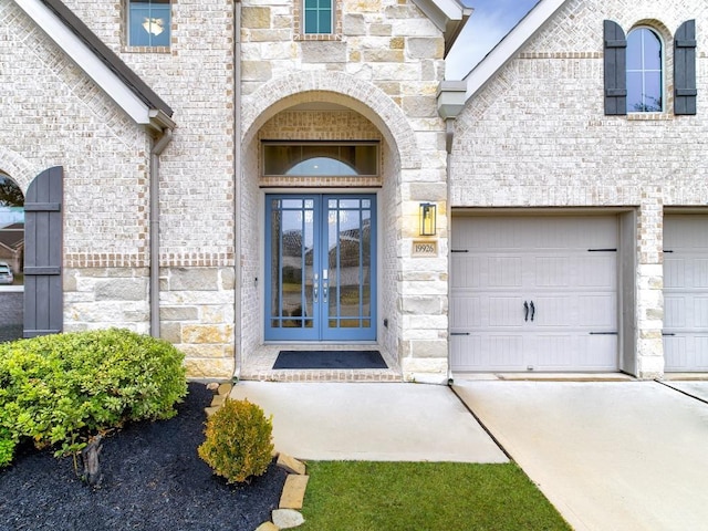 property entrance with a garage and french doors