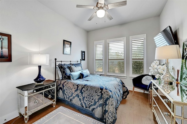 bedroom with hardwood / wood-style floors and ceiling fan