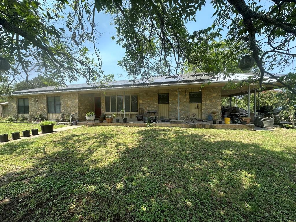 rear view of house with a lawn