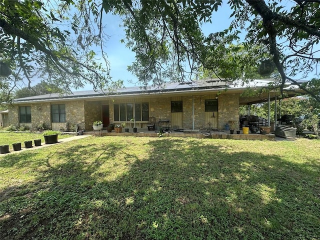 rear view of house with a lawn