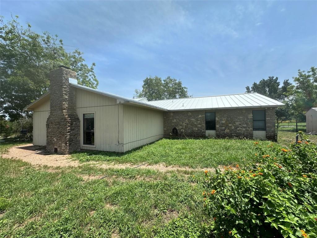 back of house with a lawn