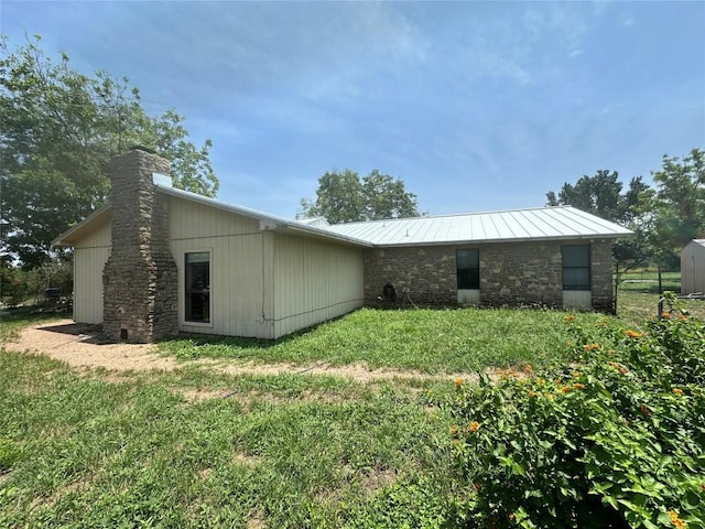 back of house with a lawn