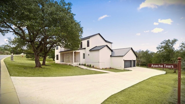 view of property exterior featuring a garage and a lawn