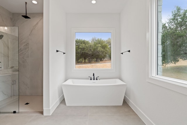 bathroom with tile patterned floors and independent shower and bath