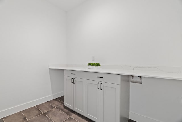 washroom with dark tile patterned floors