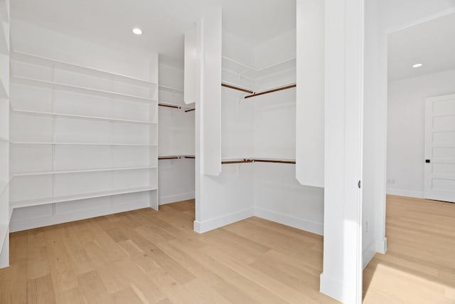 walk in closet with light wood-type flooring