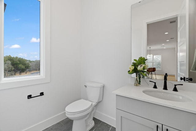 bathroom featuring vanity and toilet