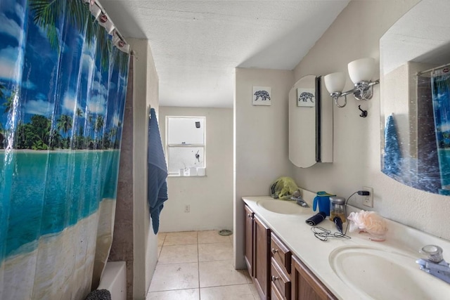 bathroom featuring vanity, tile patterned flooring, and a textured ceiling