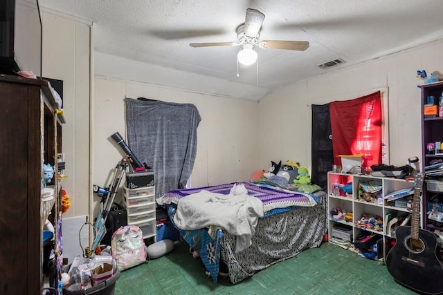 bedroom featuring vaulted ceiling, ceiling fan, and a textured ceiling