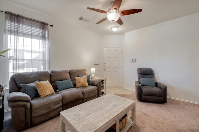 carpeted living room featuring ceiling fan