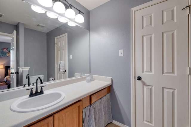 bathroom featuring vanity and toilet