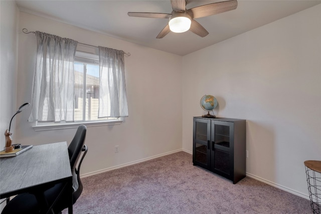 carpeted office featuring ceiling fan