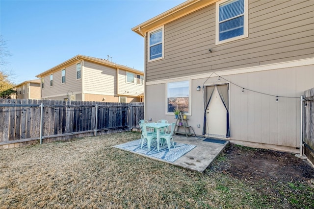 back of property with a patio area and a lawn