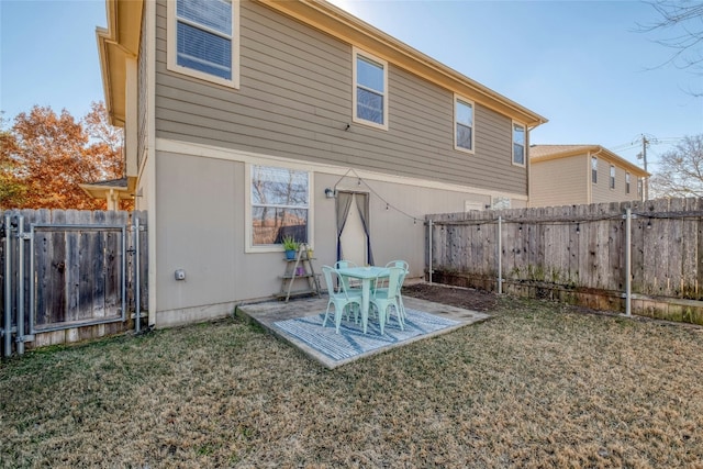 rear view of house with a yard and a patio