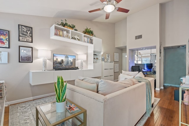 living room with high vaulted ceiling, hardwood / wood-style floors, and ceiling fan