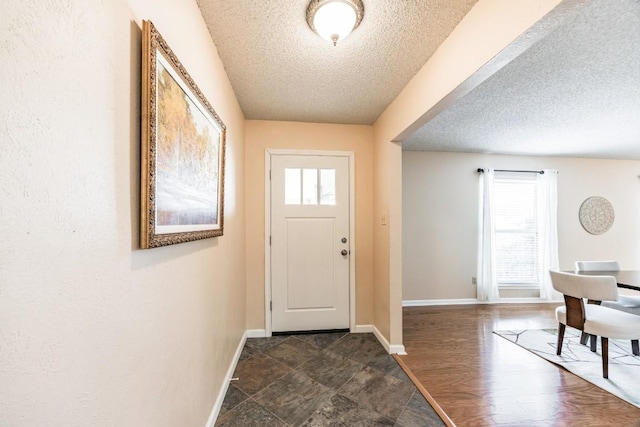 entryway featuring dark hardwood / wood-style floors and a textured ceiling