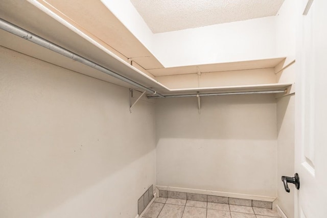 walk in closet featuring light tile patterned flooring