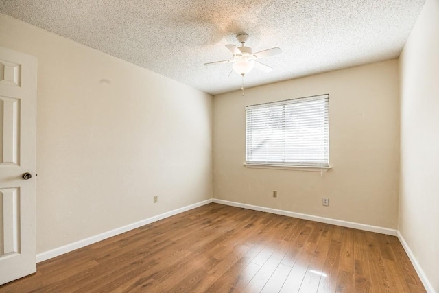 unfurnished room featuring hardwood / wood-style flooring, ceiling fan, and a textured ceiling