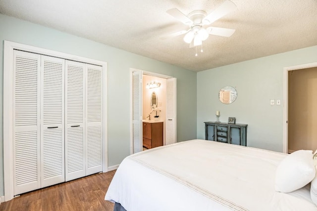 bedroom with ensuite bath, wood-type flooring, a textured ceiling, a closet, and ceiling fan