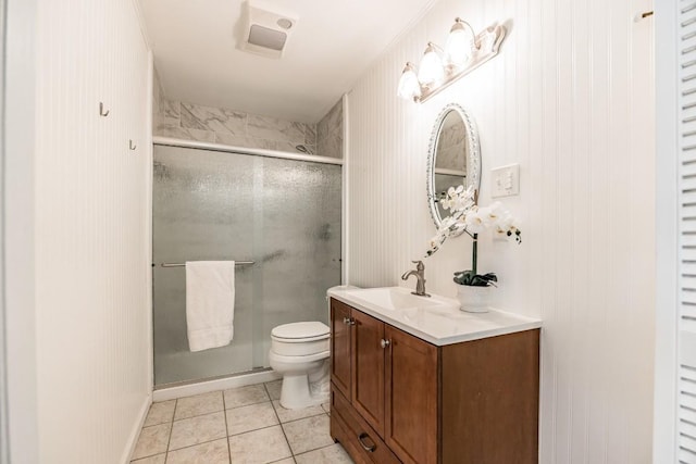 bathroom with tile patterned flooring, vanity, an enclosed shower, and toilet