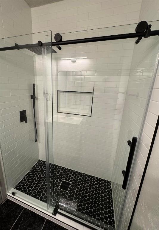 bathroom with a shower with shower door