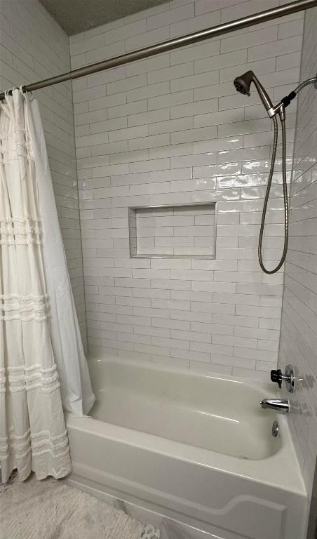 bathroom with shower / bath combination with curtain