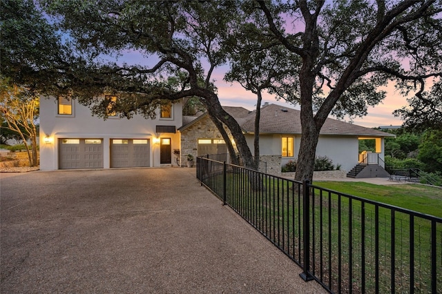 view of front facade featuring a garage and a lawn