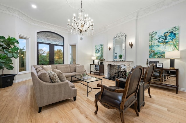 living room featuring crown molding, light hardwood / wood-style flooring, and french doors