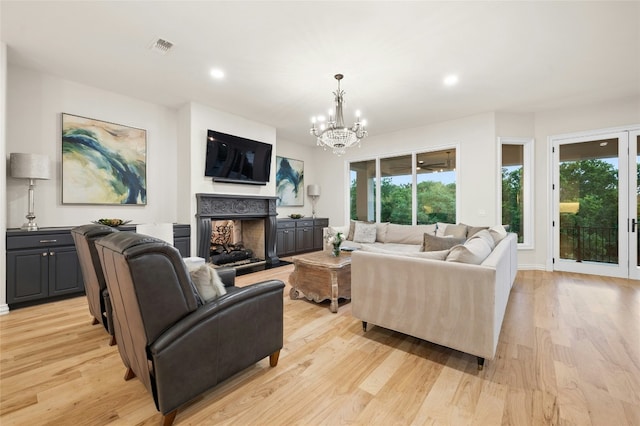 living room featuring light hardwood / wood-style flooring and a notable chandelier