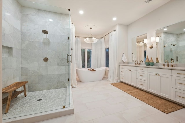 bathroom featuring plus walk in shower, vanity, and an inviting chandelier