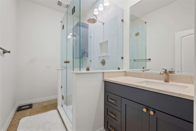 bathroom with vanity, tile patterned floors, and walk in shower