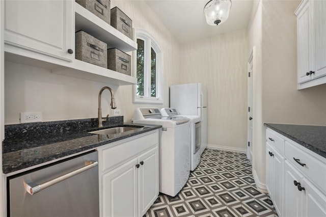 clothes washing area with sink and independent washer and dryer